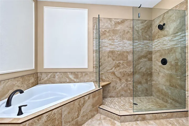 Second bfloor bathroom shows garden tub and glass enclosure walk in shower