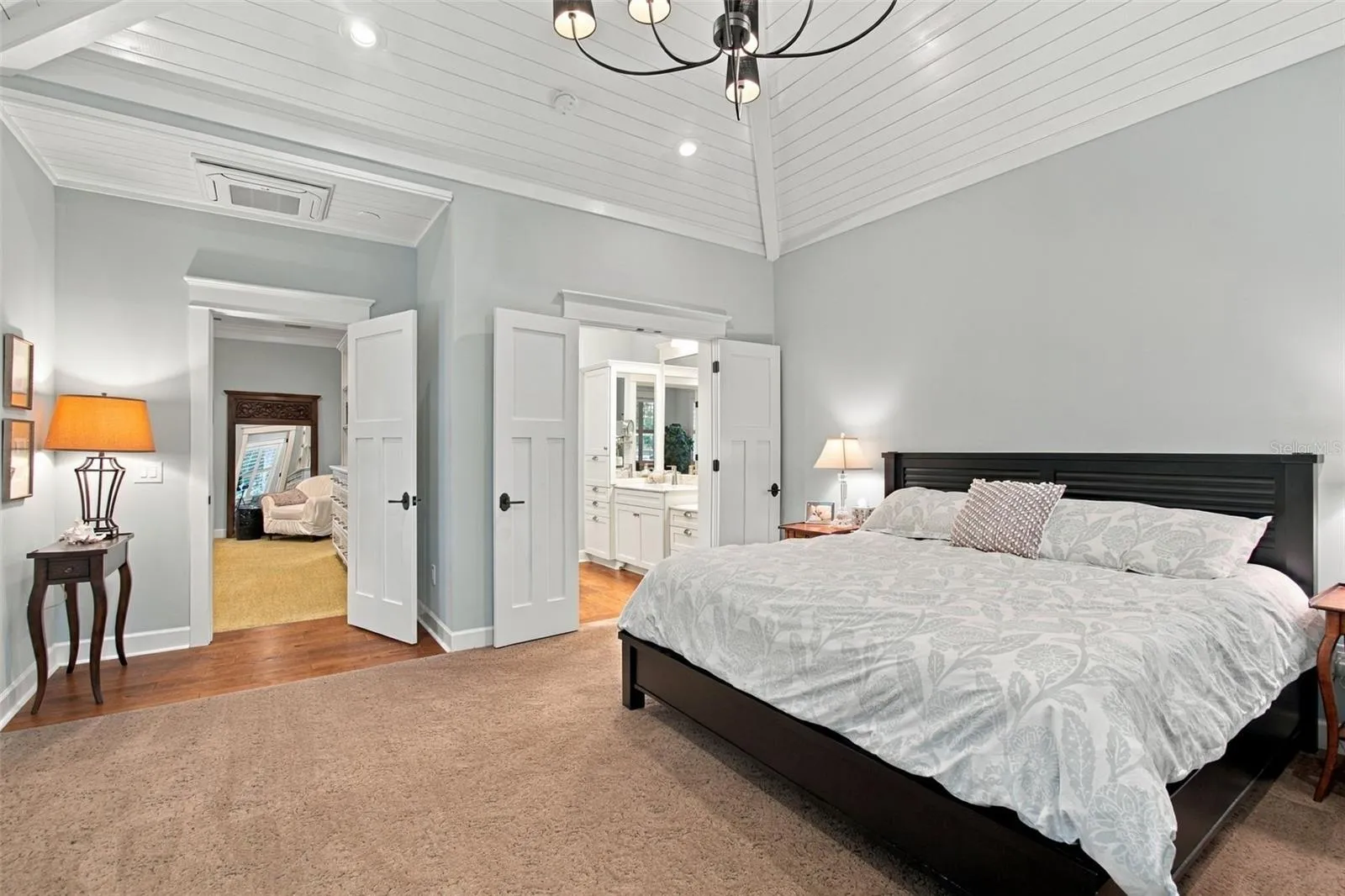 First flood Primary Bedroom with beautiful valuted ceiling with custom wood details..