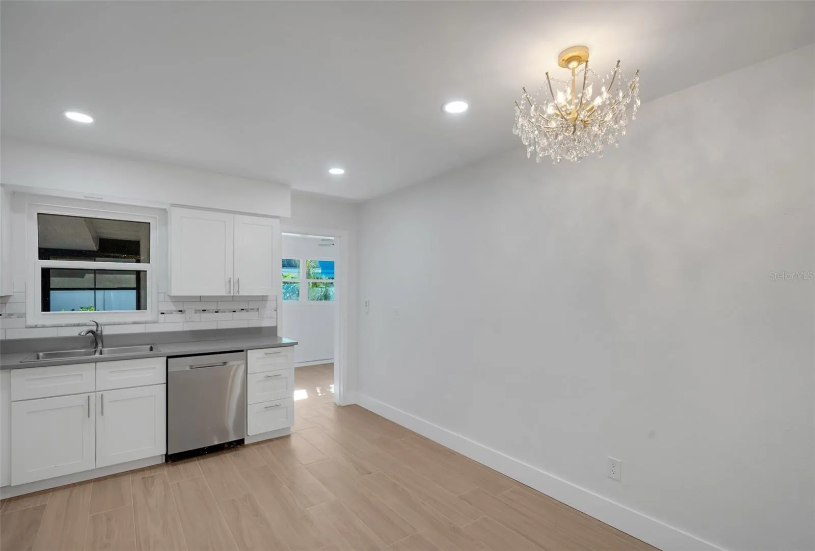 spacious kitchen with breakfast nook and beautiful crystal lamp