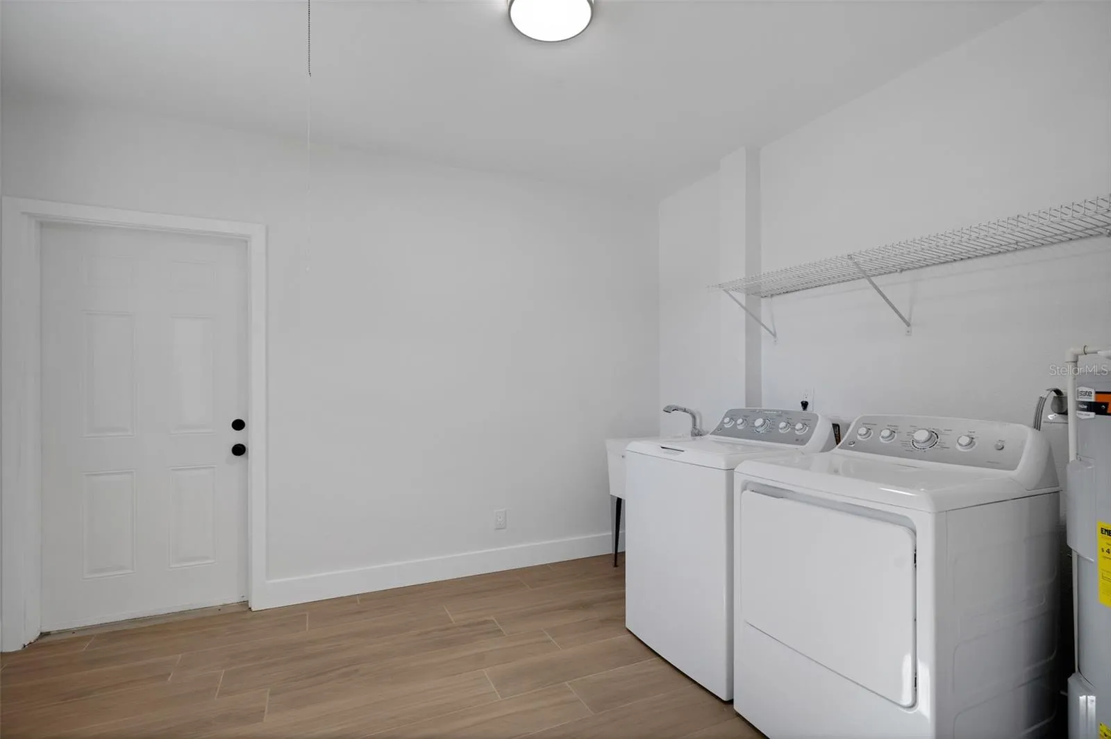 separate laundry room with door to outside covered patio