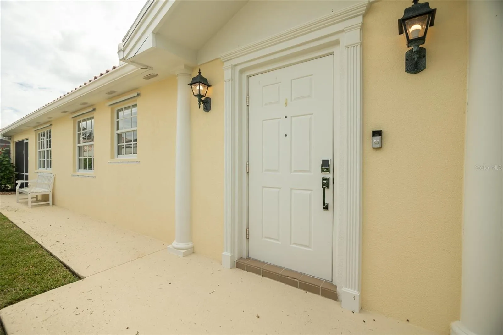 View of walk way leading to front door and beyond to the seprate pool entrance.