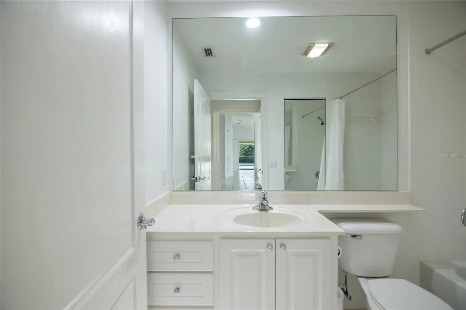 Ensuite guest bath with a tub.