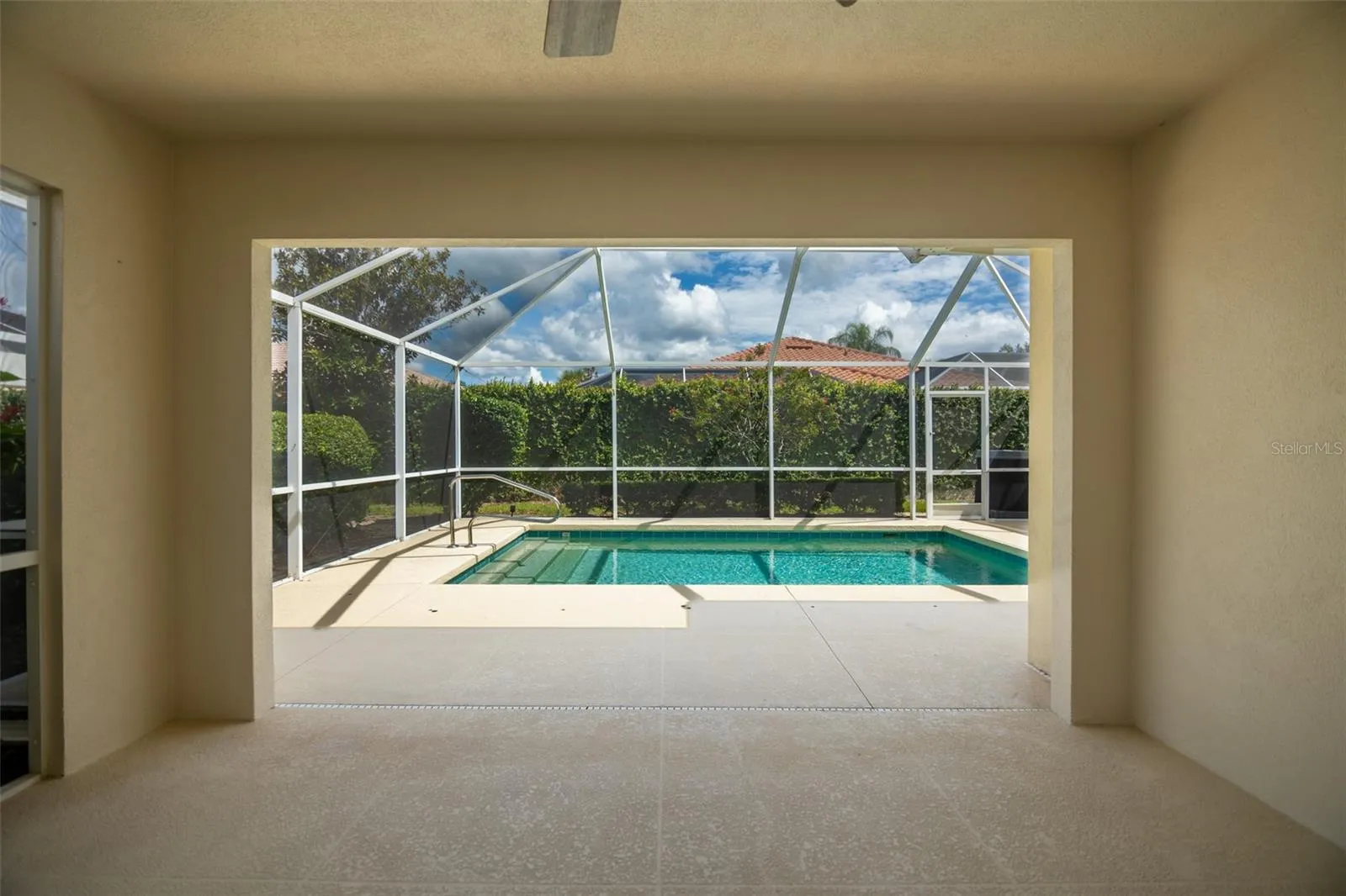 Back patio screen door on left with view of the pool in the center.