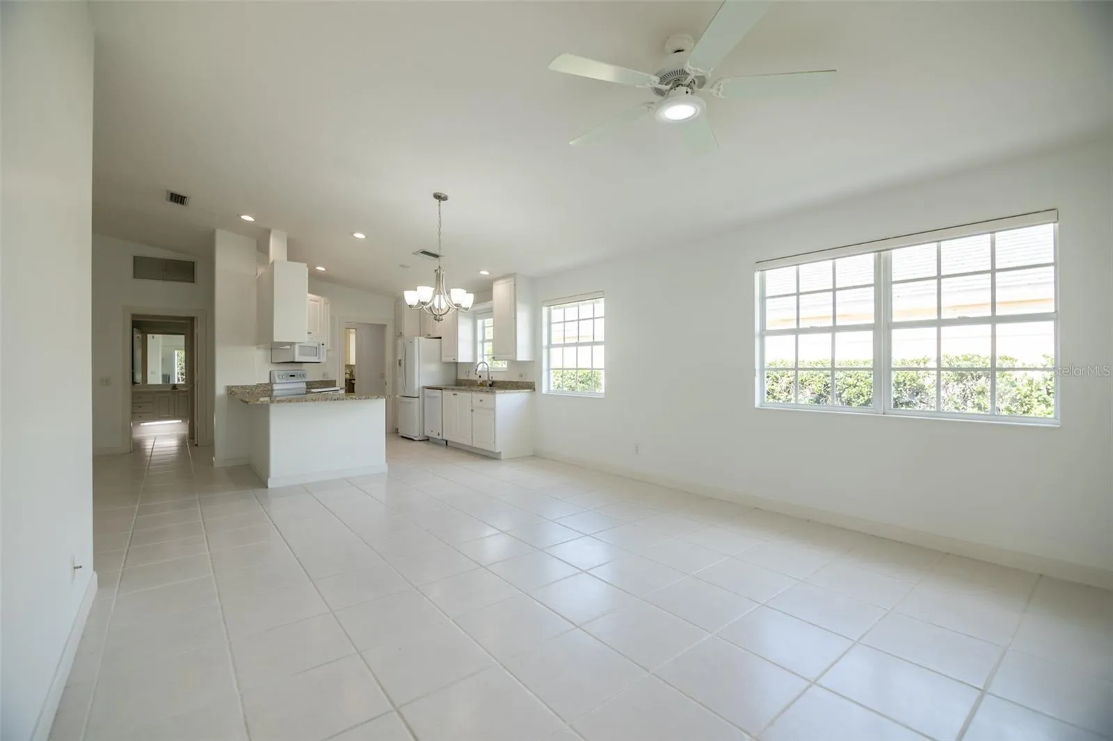 Dining and or living room with views to the kitchen and formal living room.