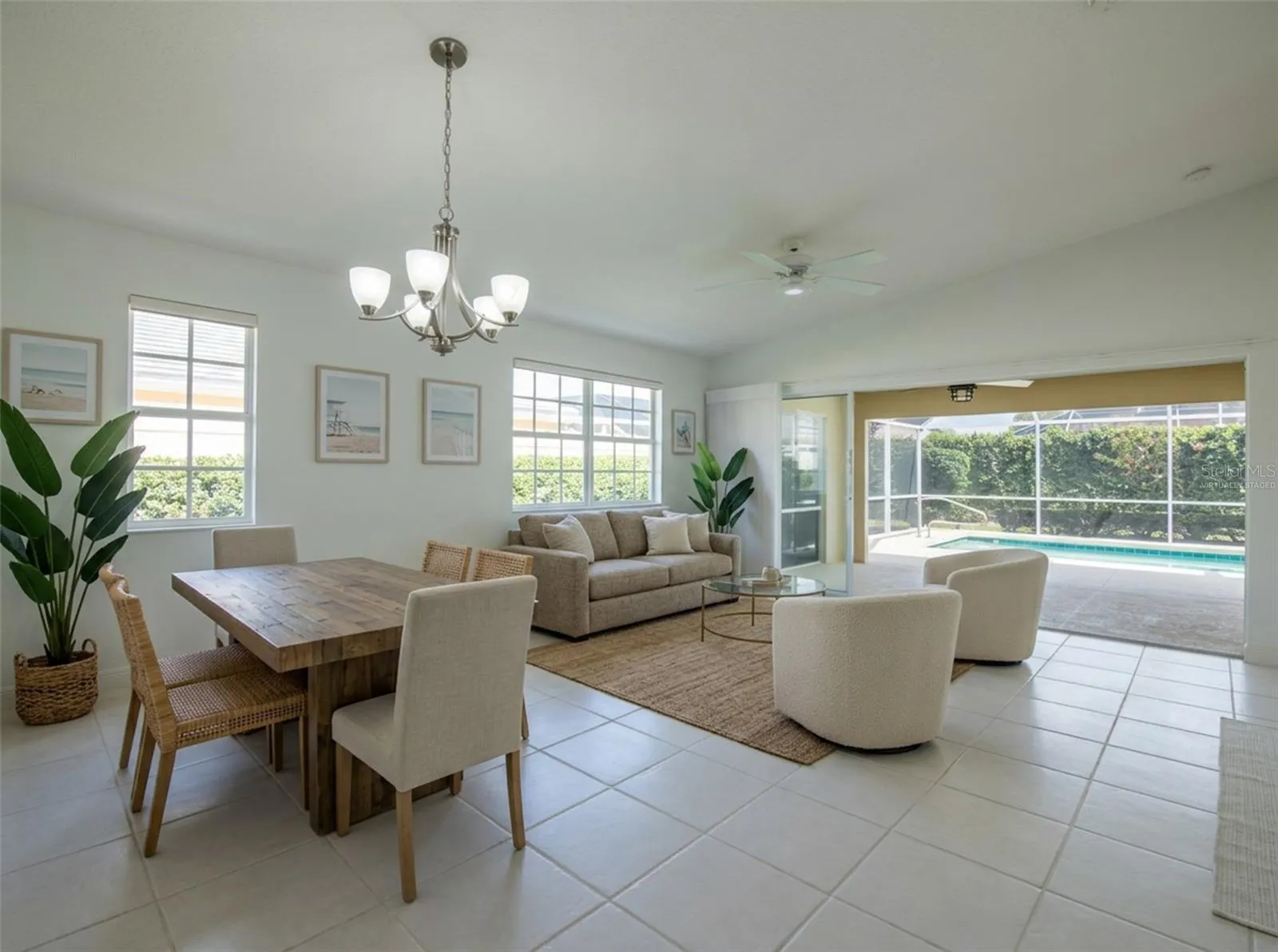 Virtually Staged Dining and Living Room with views to the Pool.