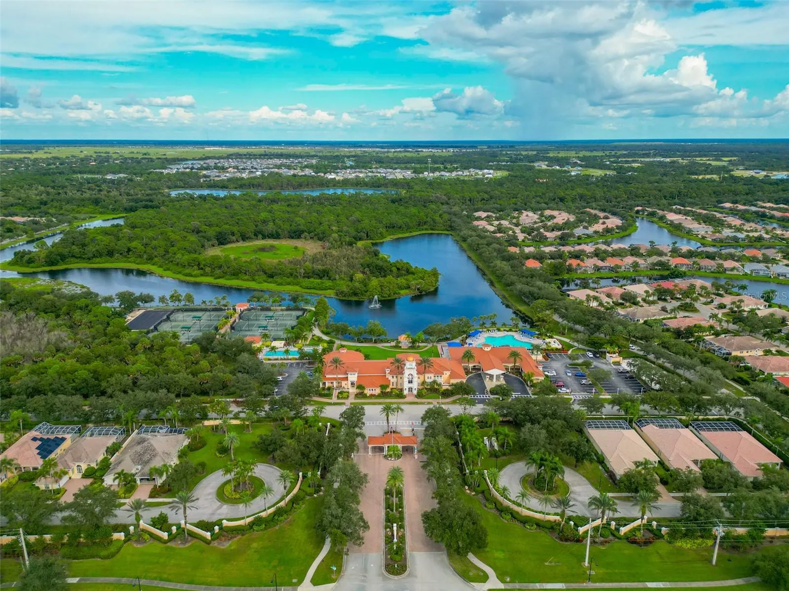 Front on sky view of neighborhood and recreational facilities.