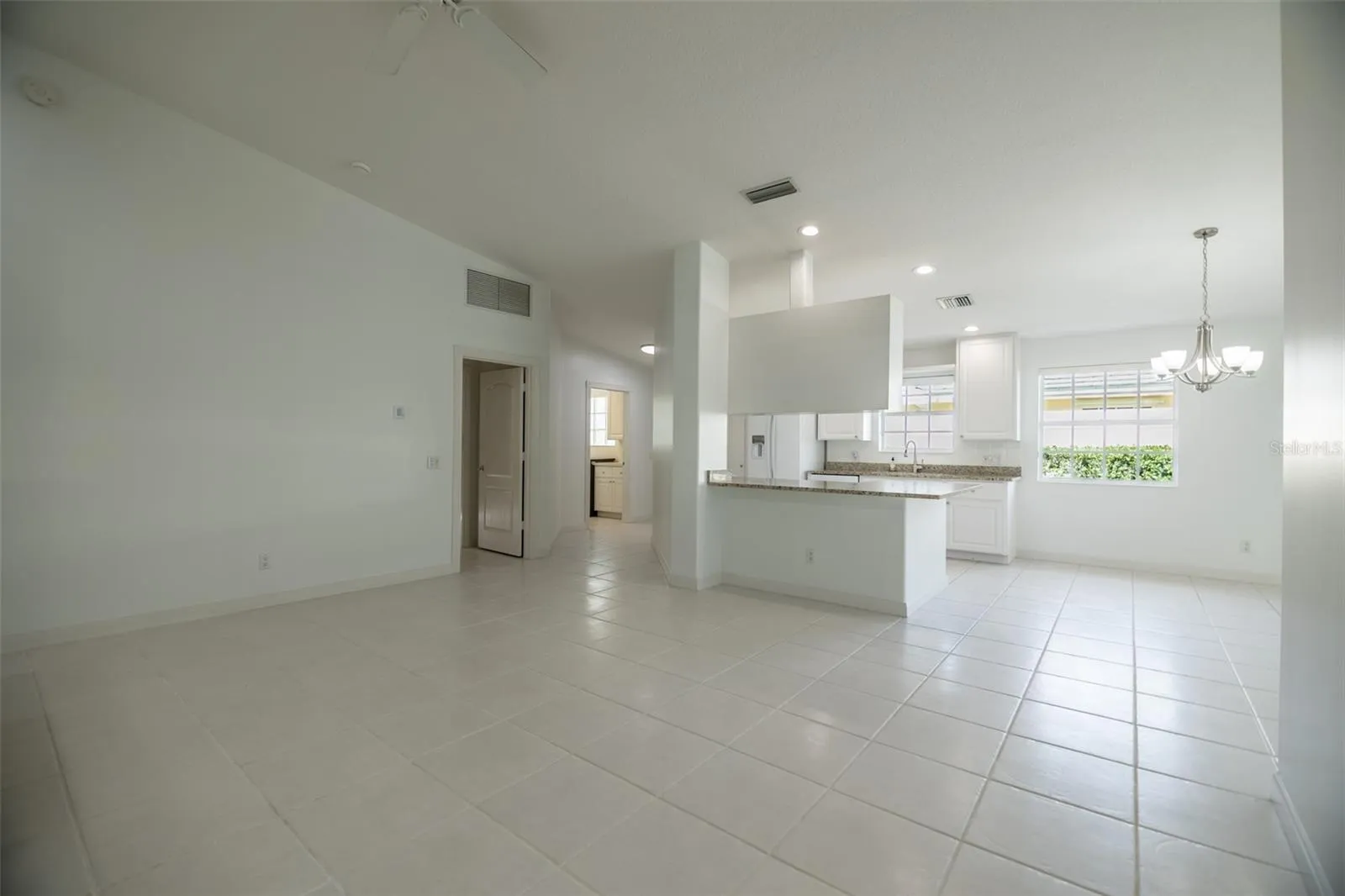 Formal living room looking towards the kitchen and entrance.