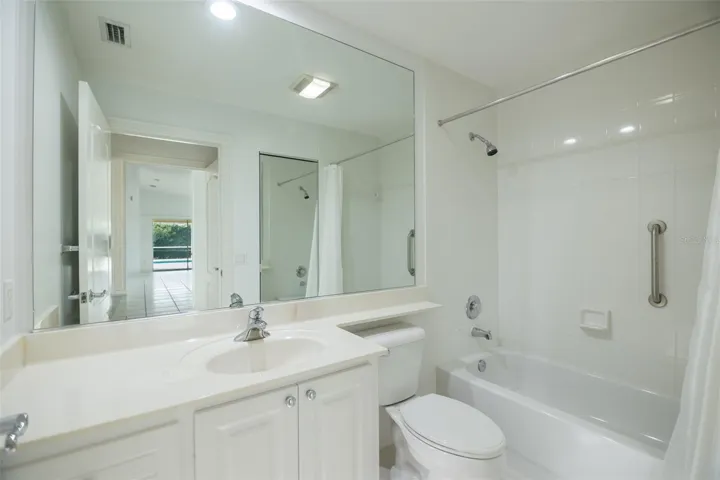 Ensuite guest bath with a tub.