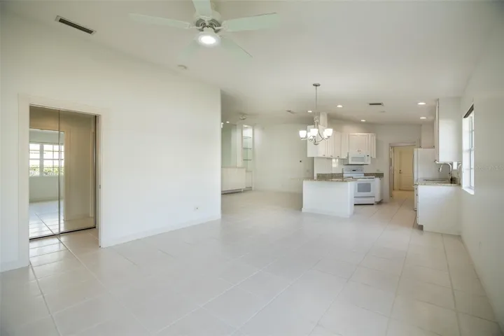 Dining and or living room with views to the kitchen and formal living room as well as the primary suite.