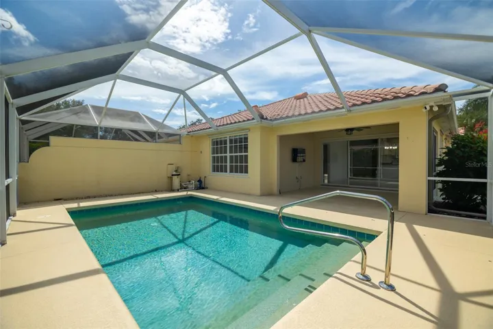 Pool, pool equipment, and a coverd back patio.