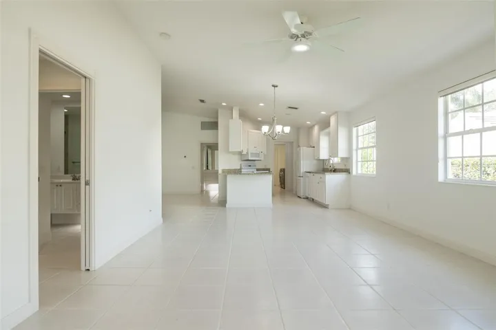 Dining and or living room with views to the kitchen and formal living room as well as the primary suite.