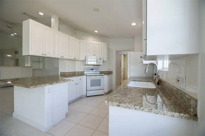 Kitchen with view of formal living room.