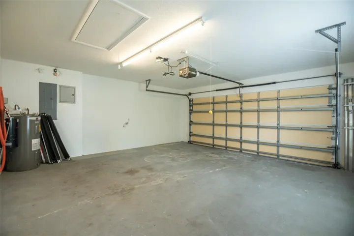 Garage with a vaccume and pool safety fence.