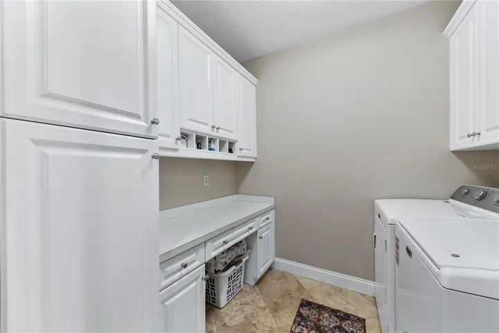 LAUNDRY ROOM LEFT SIDE CABINETS AND BUILT IN CLOSET