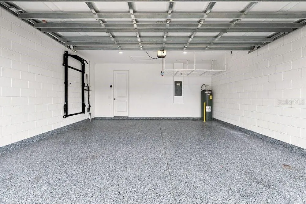 Garage with Epoxy Floors, shelf, and power rack