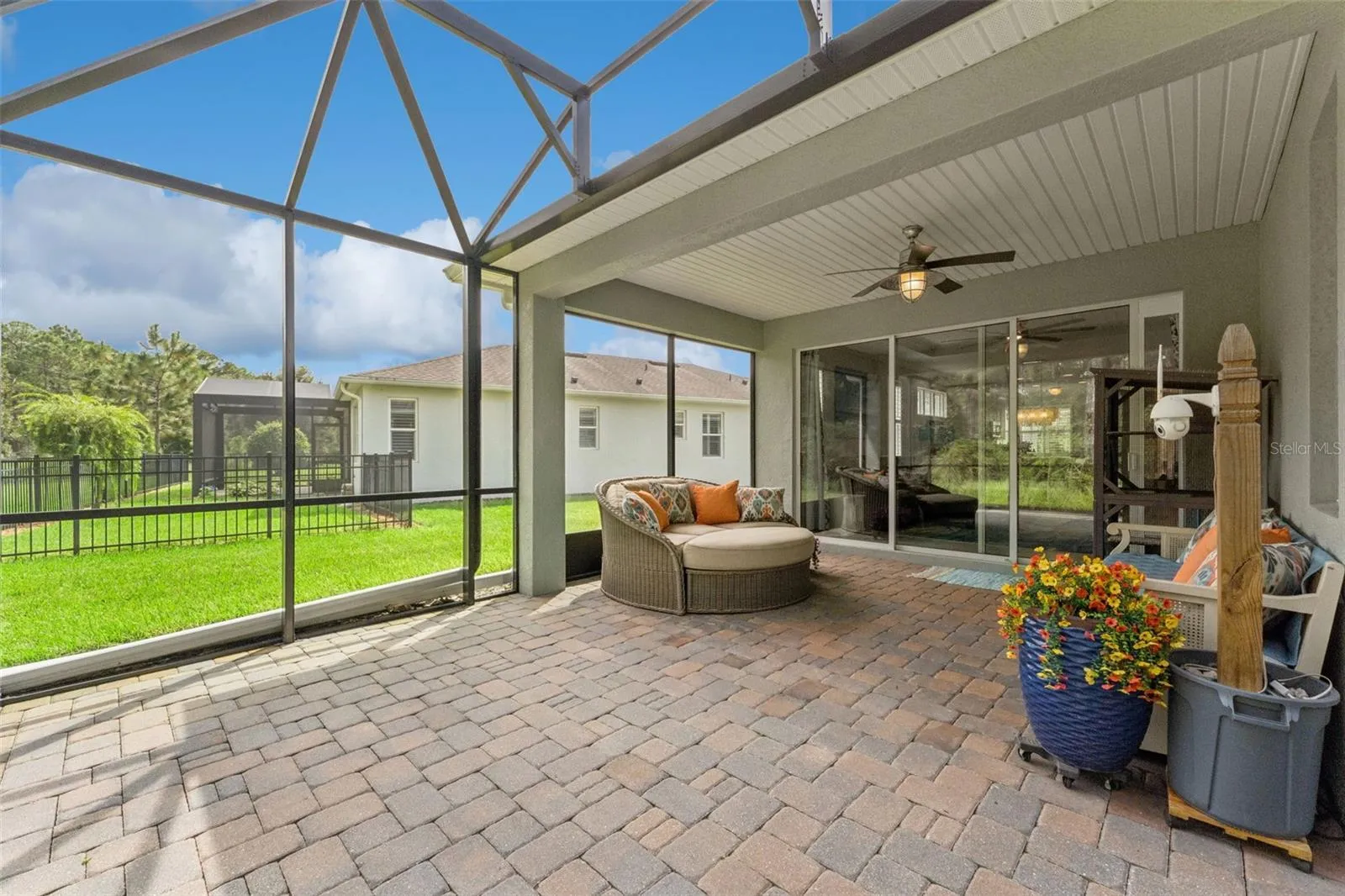 Screen enclosed covered patio w/ a ceiling fan