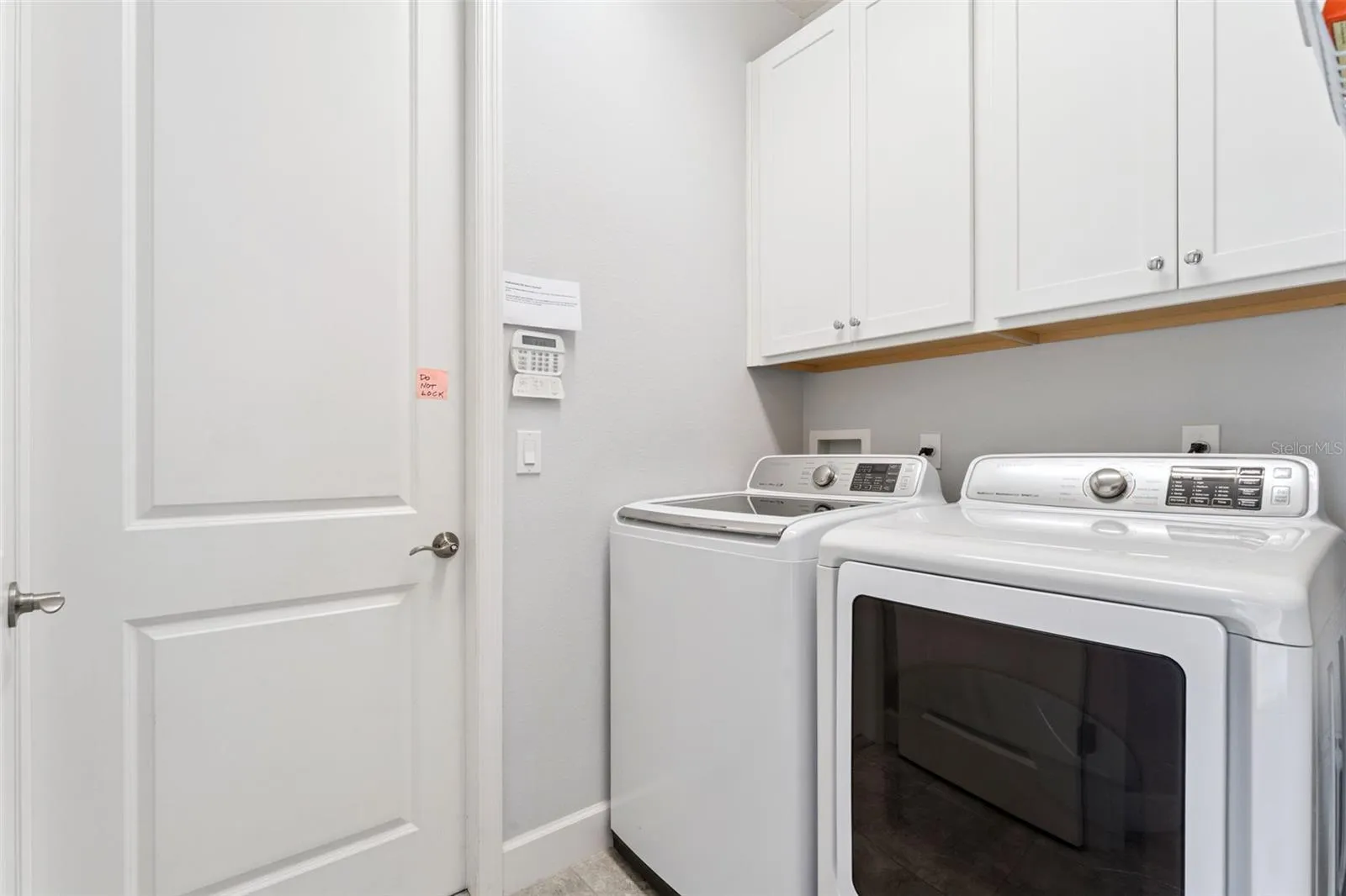 7' x 5'6" Utility Room w/ washer, natural gas dryer &amp; storage cabinets