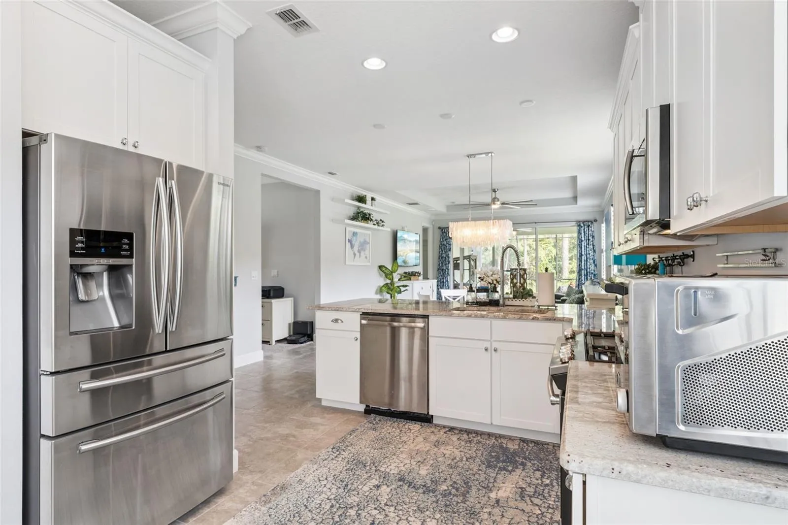 Kitchen w/ a French door style refrigerator &amp; all stainless steel appliances