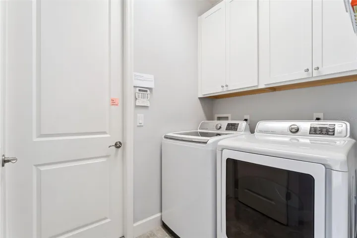 7' x 5'6" Utility Room w/ washer, natural gas dryer &amp; storage cabinets