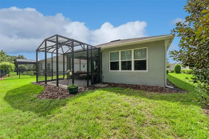 View of the screen enclosed Lanai &amp; spacious backyard