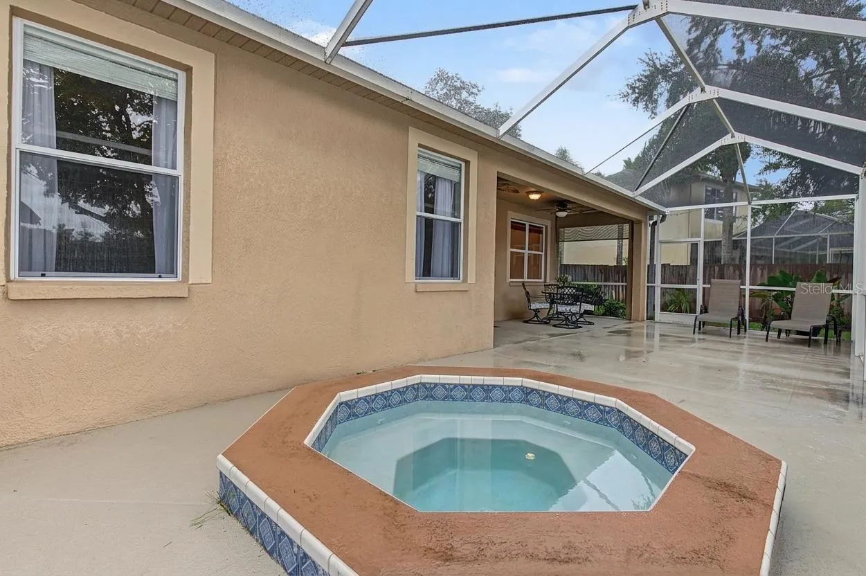 Lanai with spa overlooking the pond