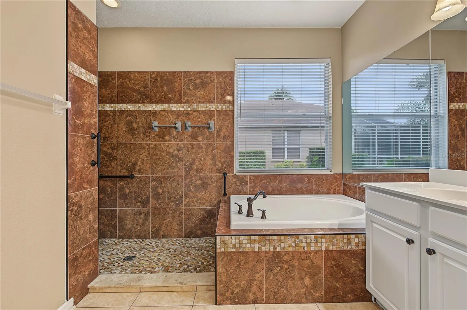 Master Bathroom, separate tub and shower, double vanities and a ceiling fan.