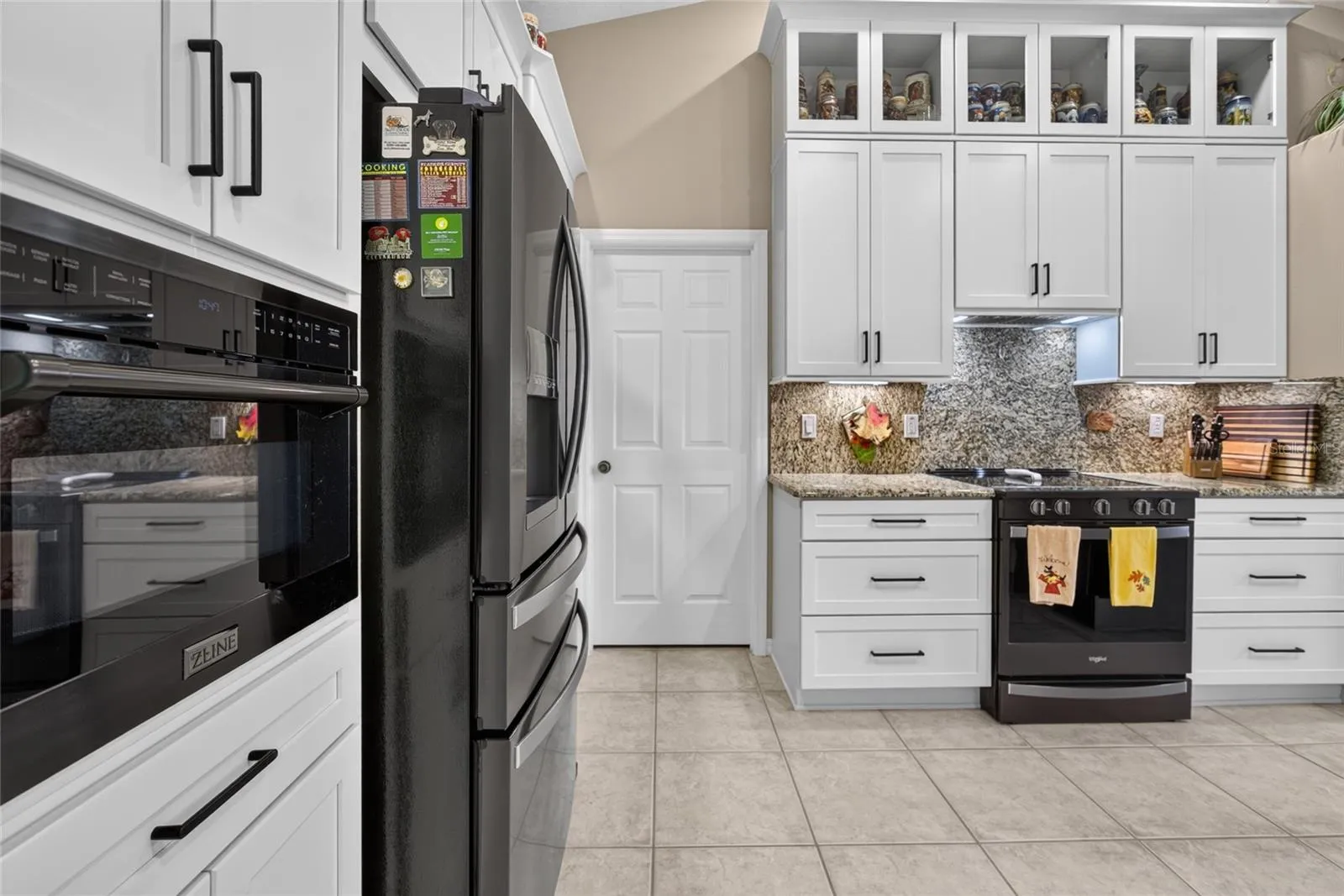 Kitchen with beautiful granite counters and backsplash.