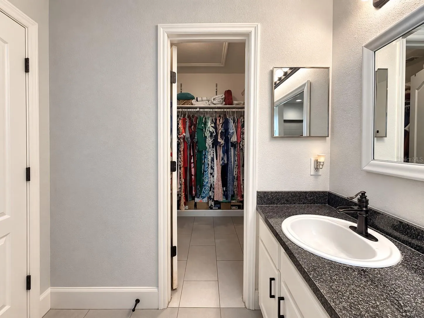 Primary bathroom with access to a spacious walk-in closet.