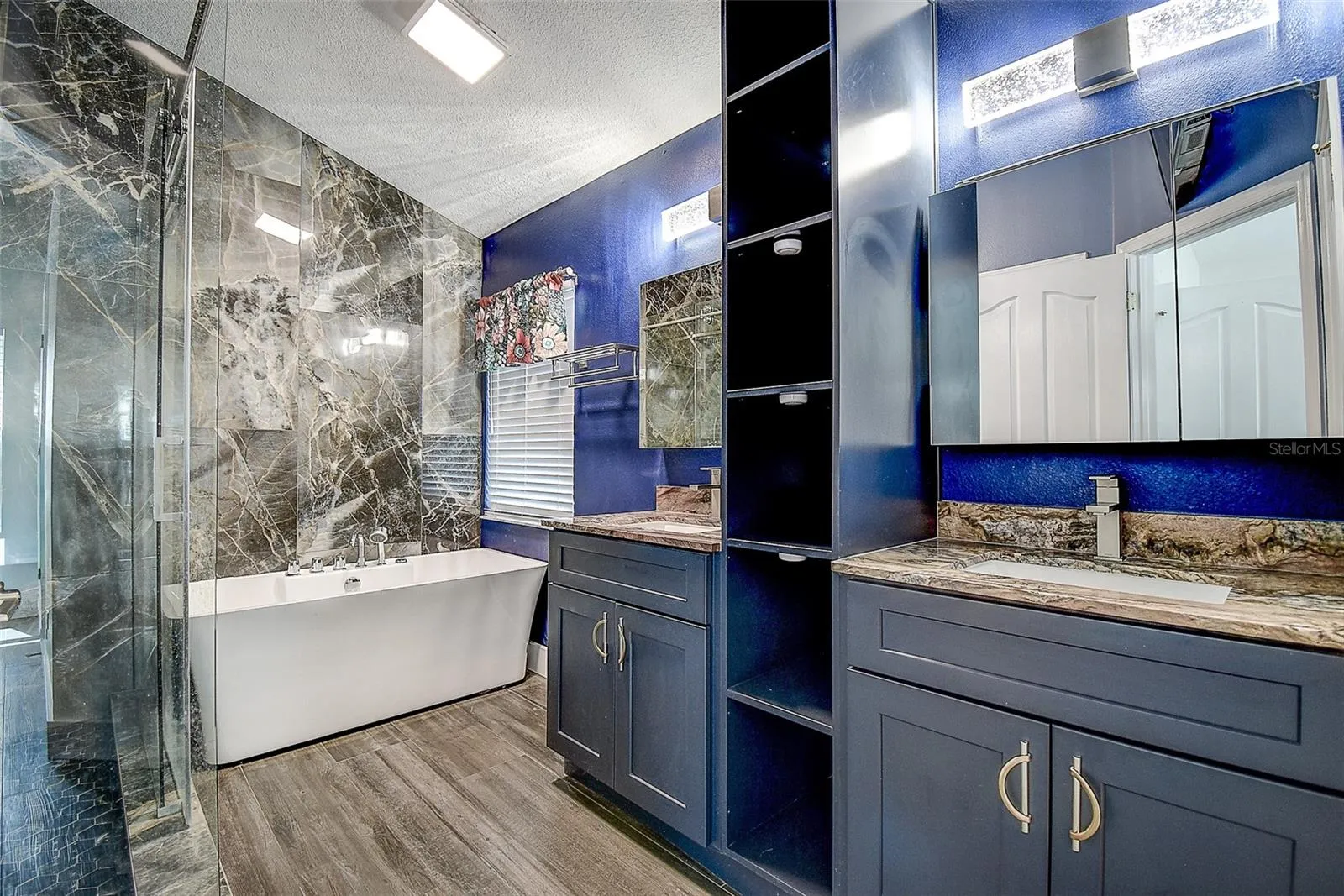 Large Spa tub and dual vanities with granite and wood cabinetry