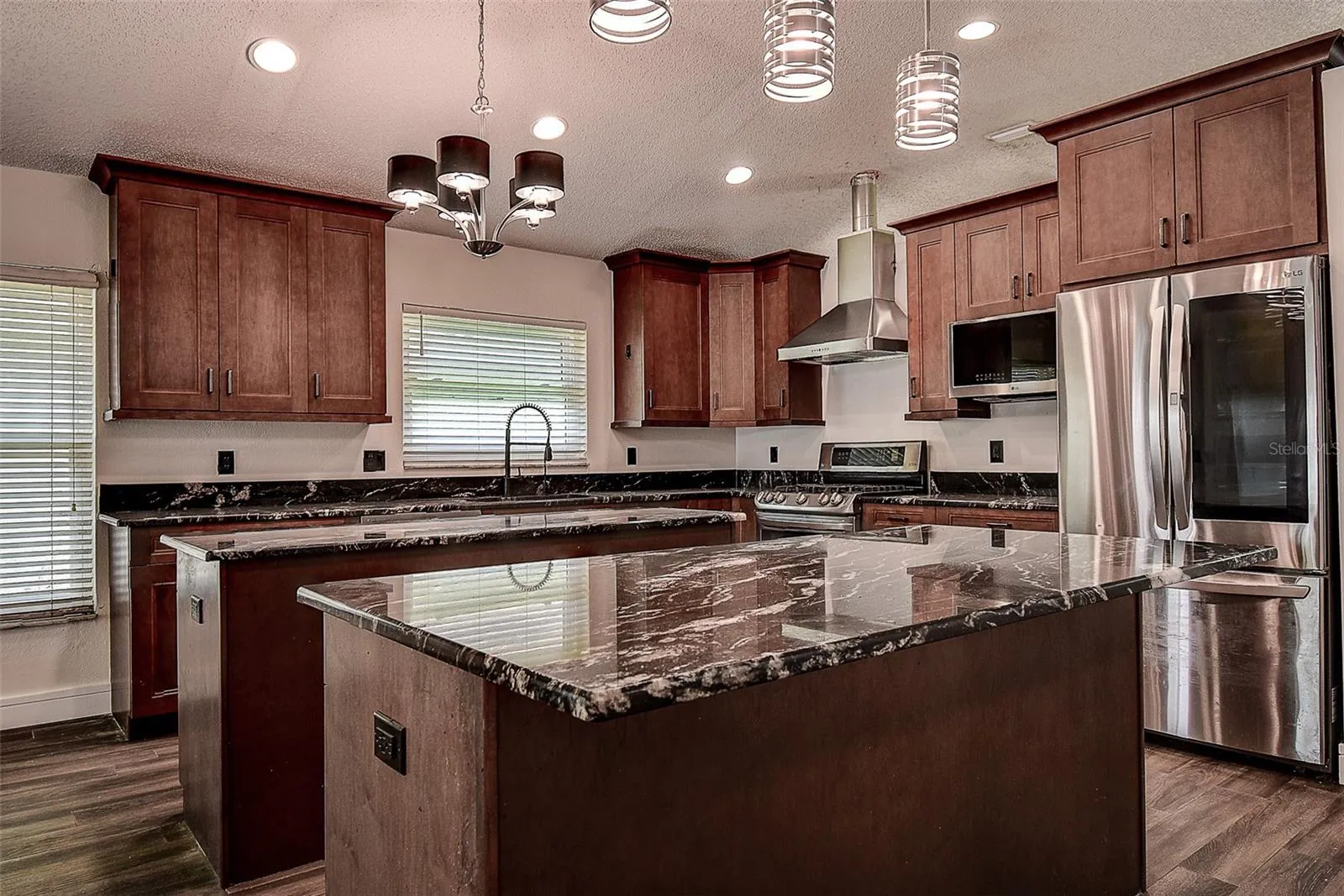 All stainless steel appliances including large LG refrigerator, range, and dishwasher