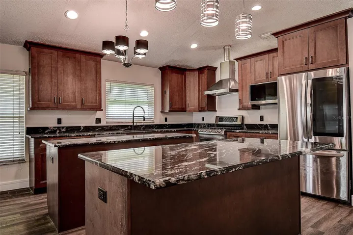 All stainless steel appliances including large LG refrigerator, range, and dishwasher