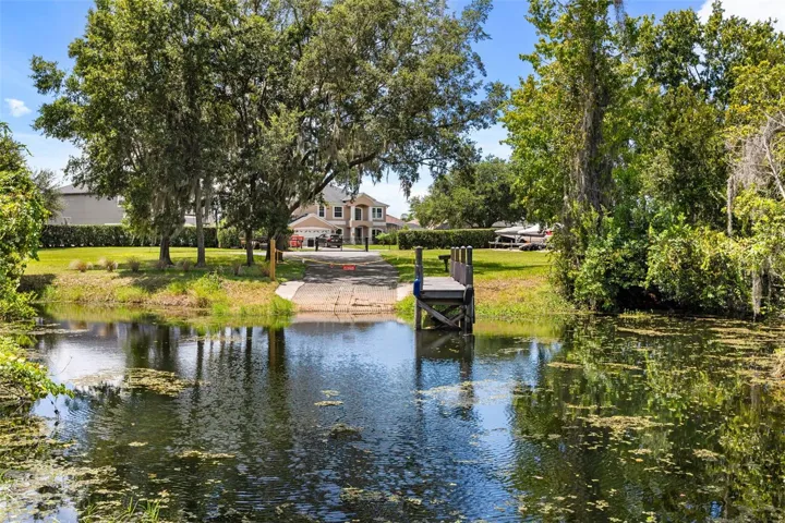 A private dock and boatlift provide access to Lake Sheen and the entire Butler Chain, while a gated community boat ramp is approximately 300 feet away.