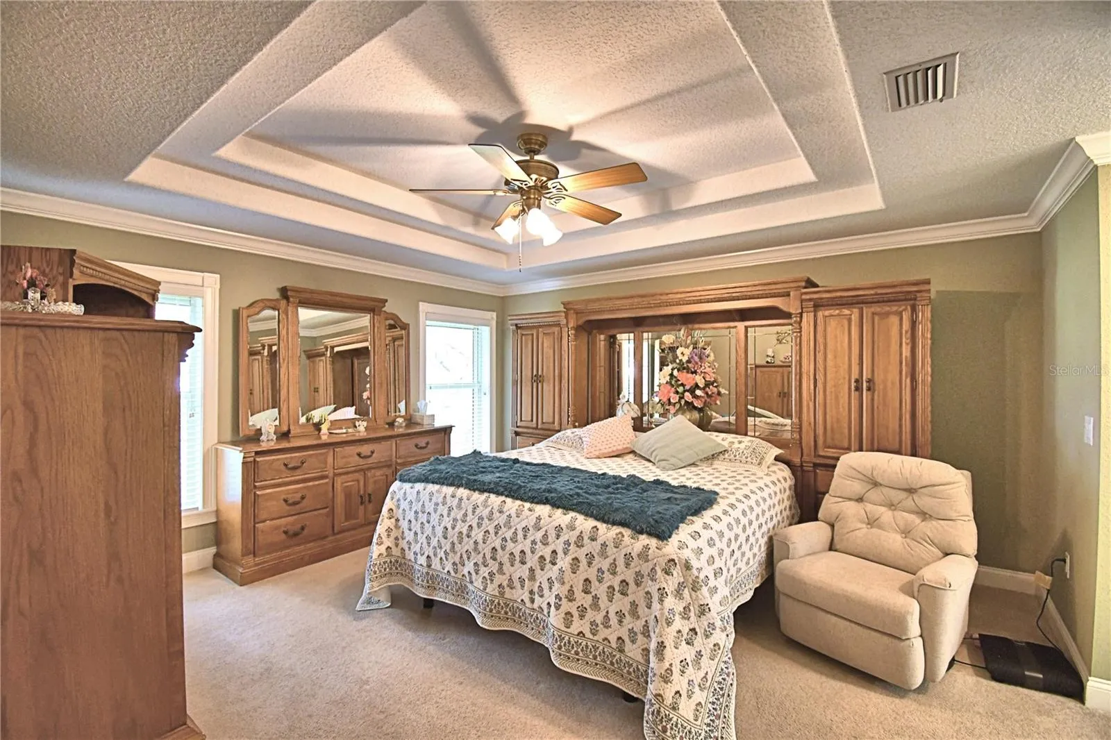 Master bedroom with tray ceilings and lake view