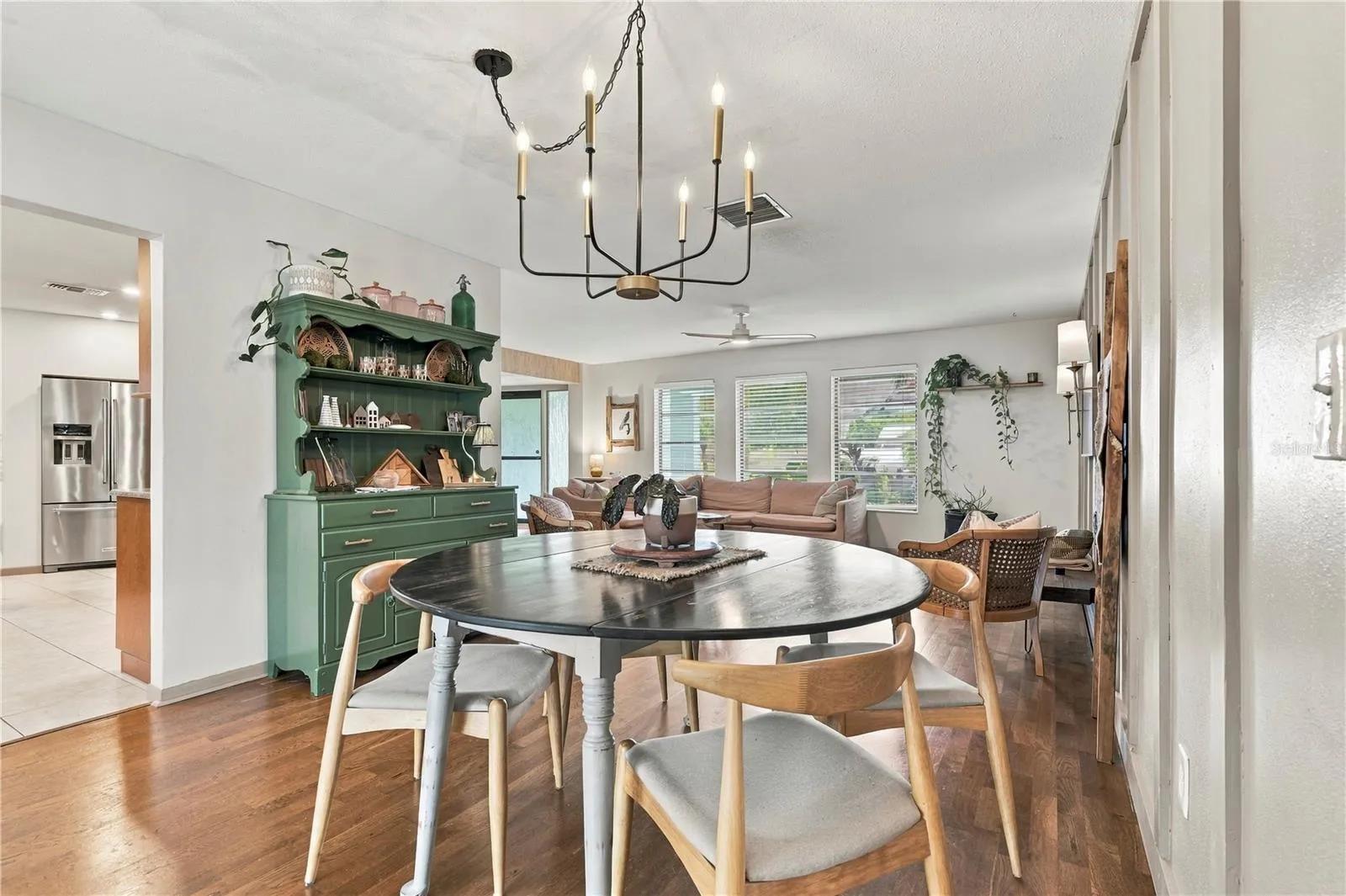Dining room looking into living space and kitchen entry