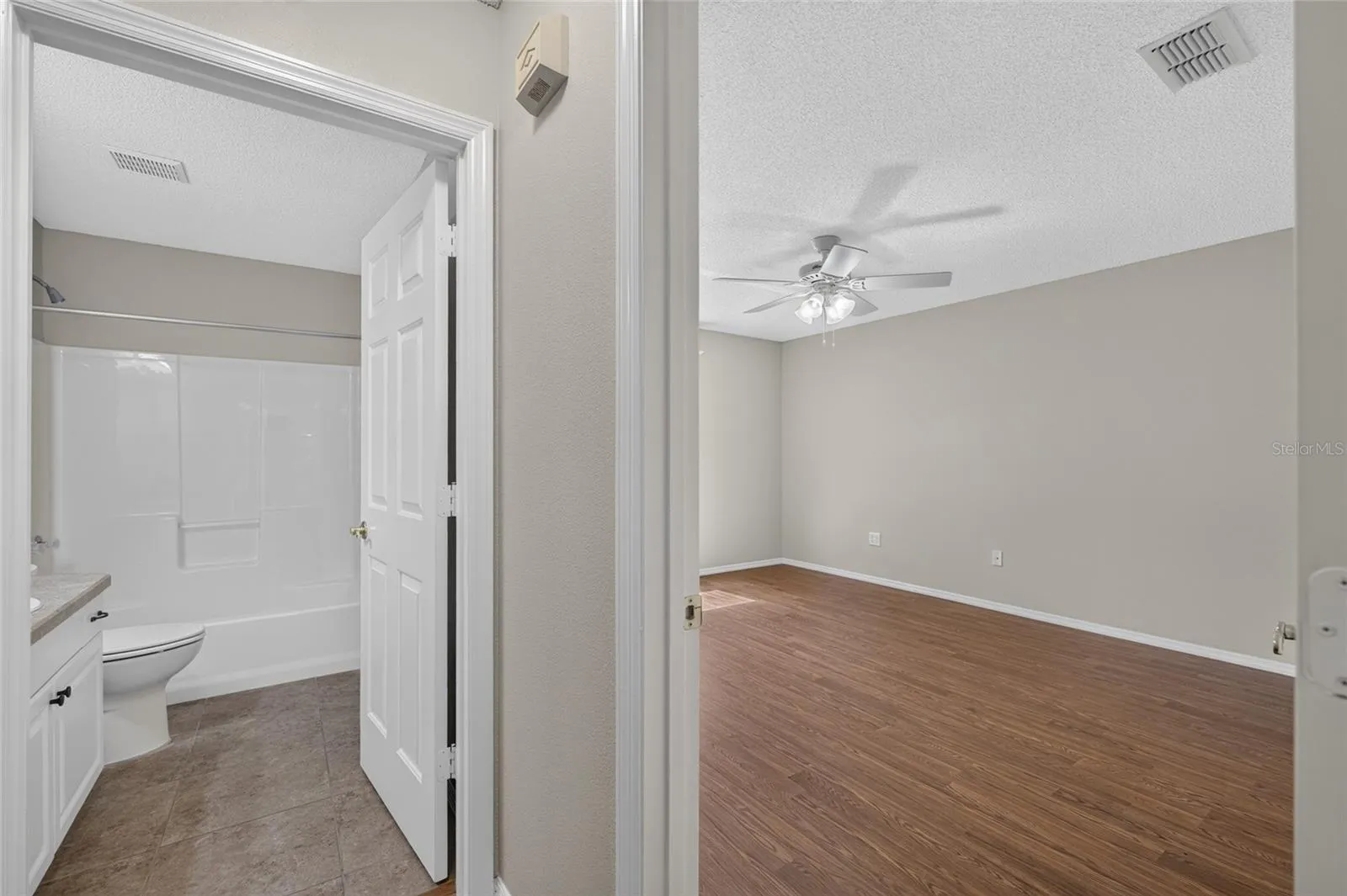 View of HALLWAY to rear of villa - PRIMARY BEDROOM doorway (R) and BATHROOM #2 doorway (L).