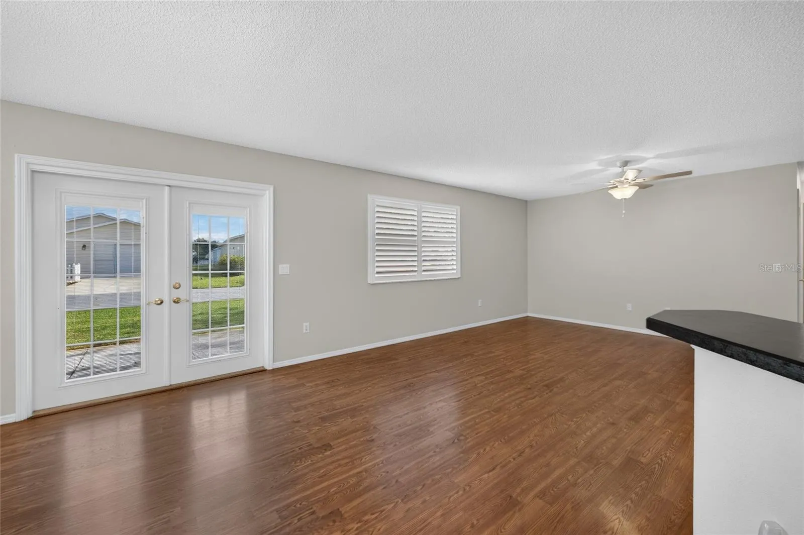 DINING/LIVING ROOMS - Freshly painted walls in a neutral palette provide a simple backdrop for the main living space.