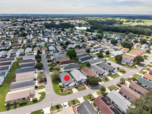 AERIAL – Looking Southwest – Patio villas here put their lanais and patios up front, facing the street, designed with community in mind, with convenient guest parking (right center) one street over.