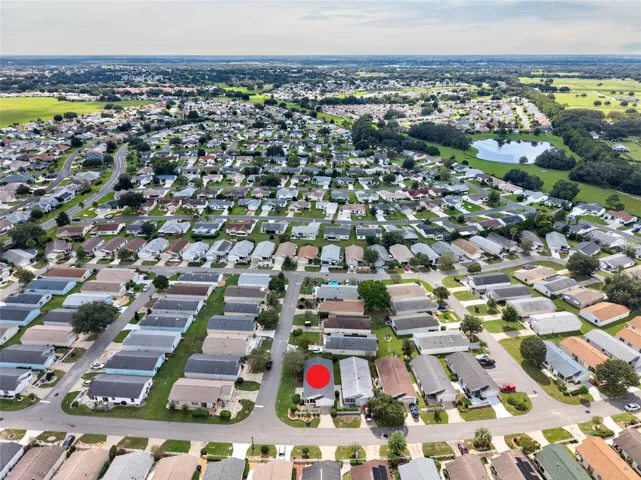 AERIAL – Looking South – CORNER LOT villa (marked) in SANTO DOMINGO, with Cazares Avenue (left), the Sharon L. Morse Owl Preserve (deep left) and golf-cart access to Lake Sumter Landing (deep center).