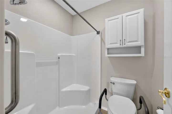 PRIMARY BATH - Close-up view shows details of the separate toilet and bathing area.