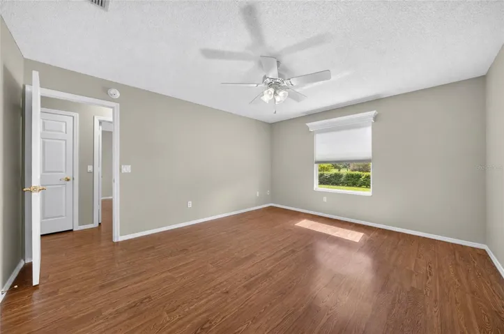 Another view of PRIMARY BEDROOM shows LINEN CLOSET in HALLWAY.