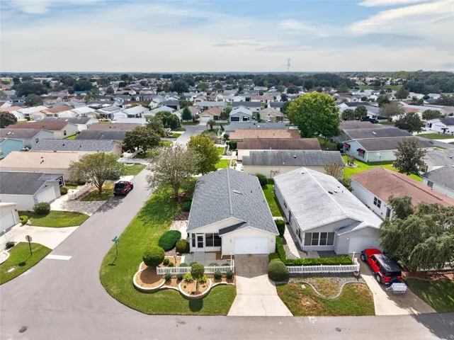 AERIAL / EXTERIOR - View of the villa, driveway and landscaping within the surrounding residential streets.