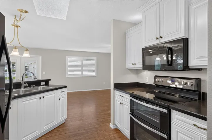 KITCHEN - SKYLIGHT brings natural light into the workspace, with a view through to the living/dining area.
