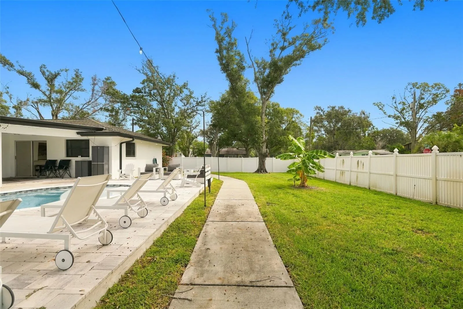 Walkway and large grassy backyard to enjoy