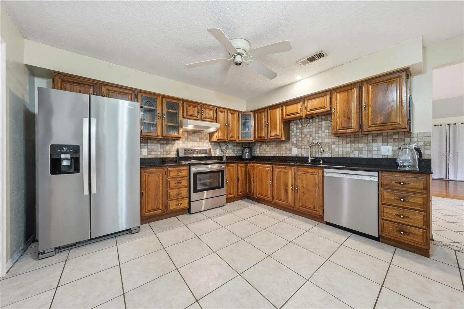 KITCHEN WITH STAINLESS APPLIANCES, SOLID WOOD CABINETS + GRANITE