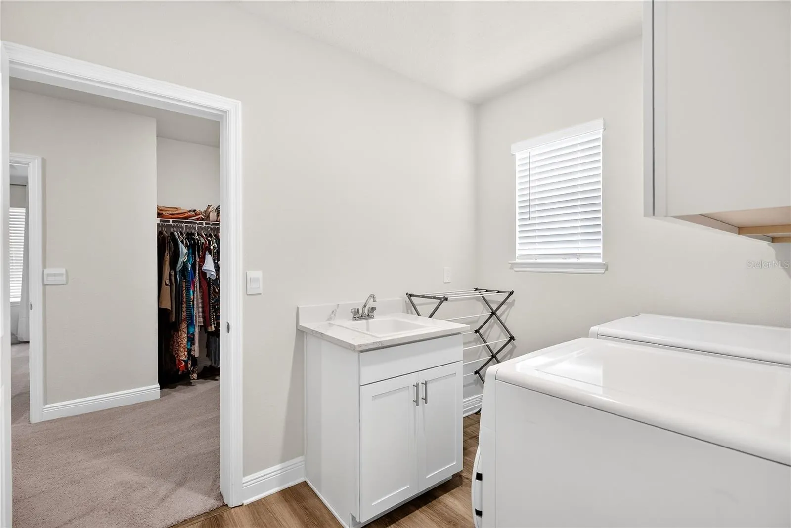 Laundry room off primary bed closet