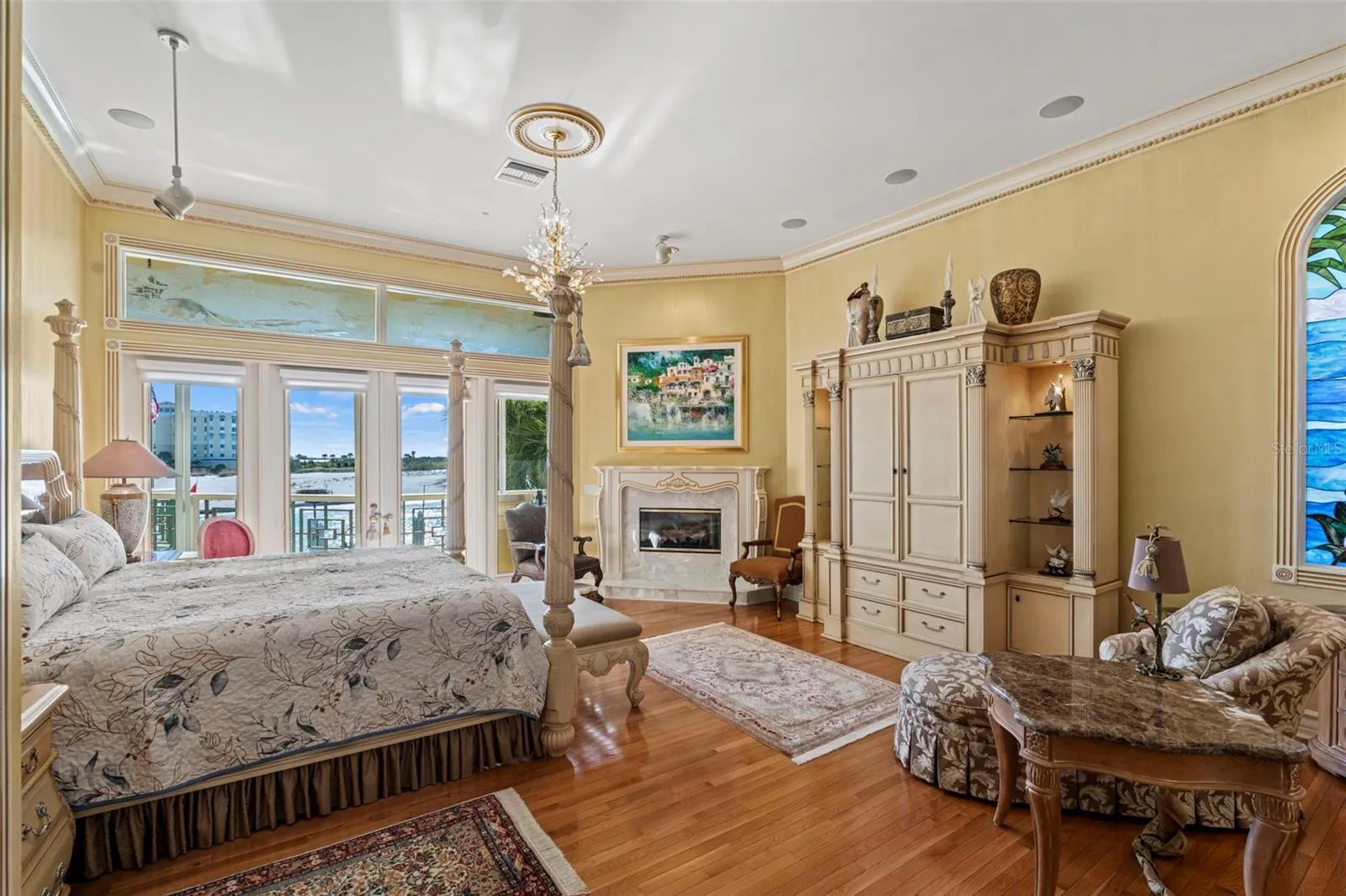 Primary Suite with Harwood Floors, Fireplace, Crown Molding and French Doors to the Balcony