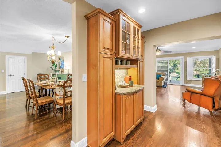 This coffee and wine bar features ample storage space and provides convenient, direct access to both the family room and the dining area.
