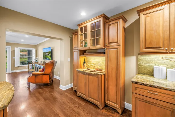 This space features a matching bar area for charcuterie or appetizers, positioned opposite the dedicated beverage station. The design includes matching granite countertops and a coordinated backsplash. The room is fully equipped and staged for holiday entertaining.