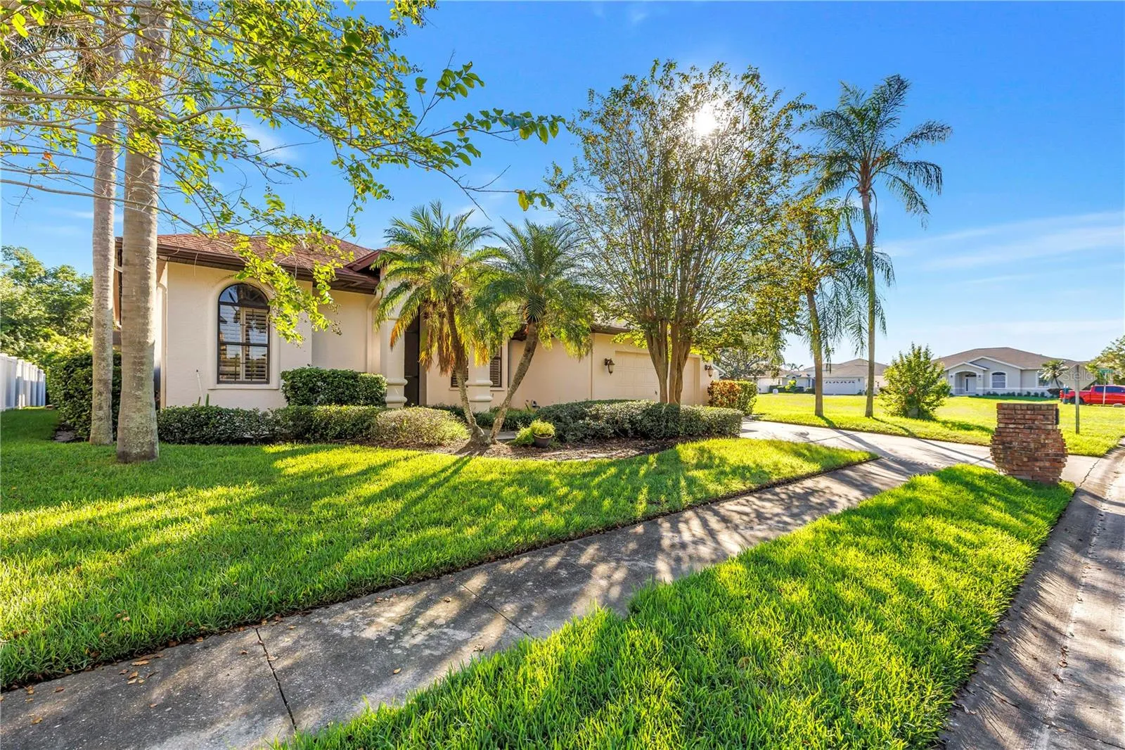 Charming exterior featuring sidewalks, a two-car driveway, and a two-car garage. Located in the beautiful Caya Costa nature preserve, perfect for safe, peaceful strolls at any time of day or night.