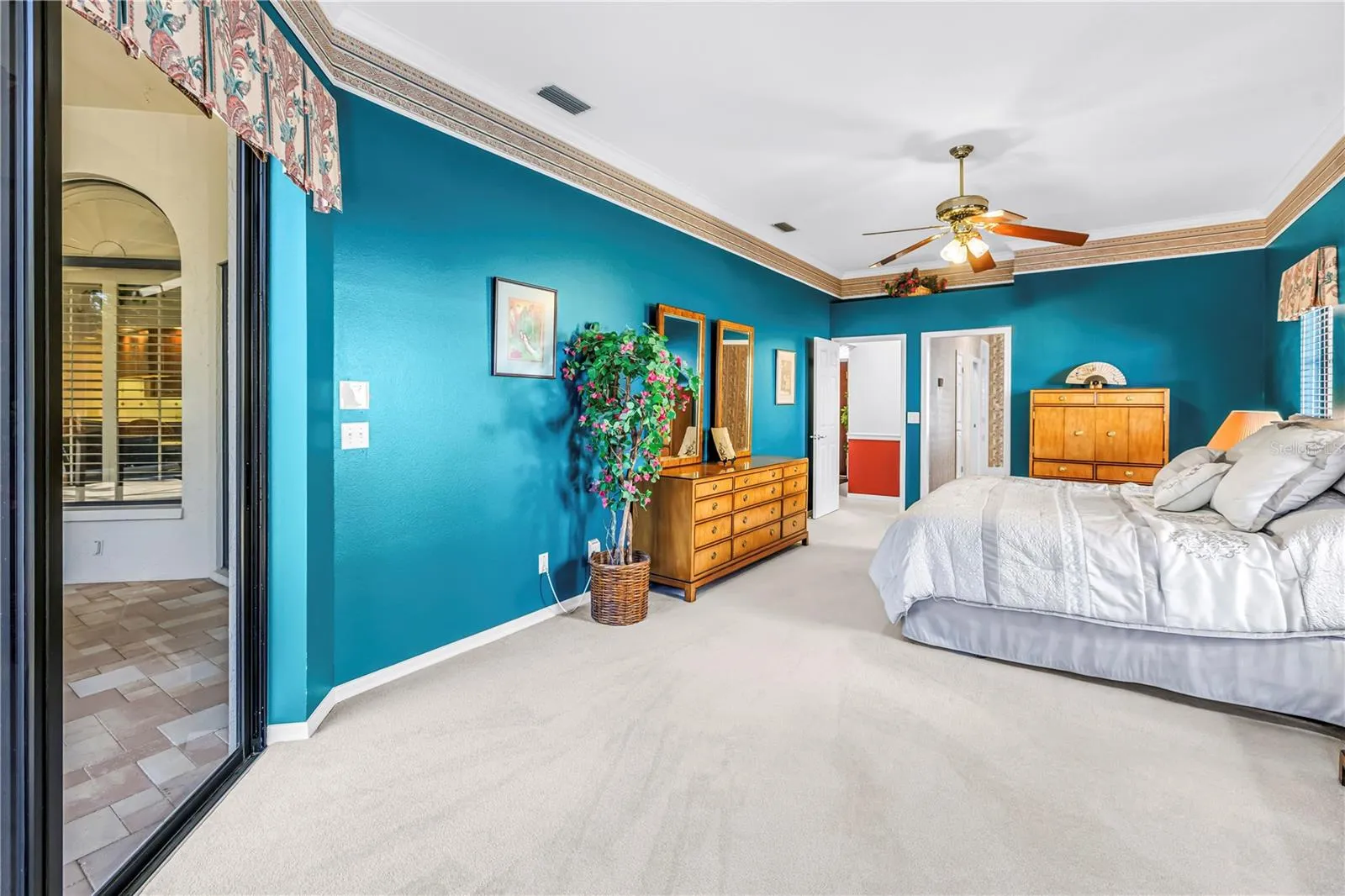 Primary Bedroom with doors to en suite bath and living room.  10 Foot Ceilings, windows and (2) 8-Foot sliders to the pool deck.  SEE VIRTUAL RENDERING IN PHOTO 61